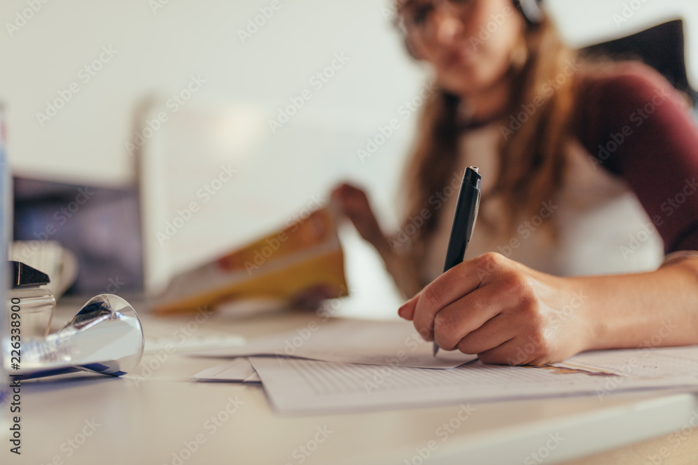 Programmer writing on codes on paper