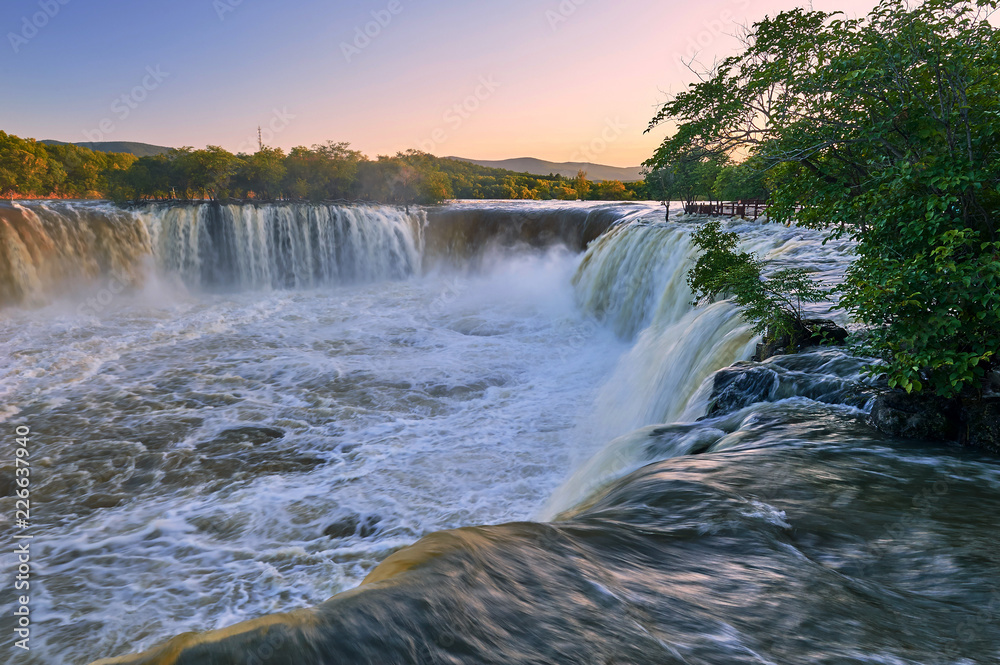 Ching-po Lake waterfalls of China sunset landscape.