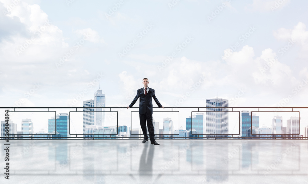 Sunrise above skyscrapers and businessman facing new day