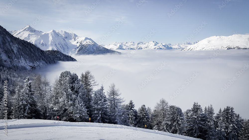 Image of ski resort in the mountains with low stratus over the valleys