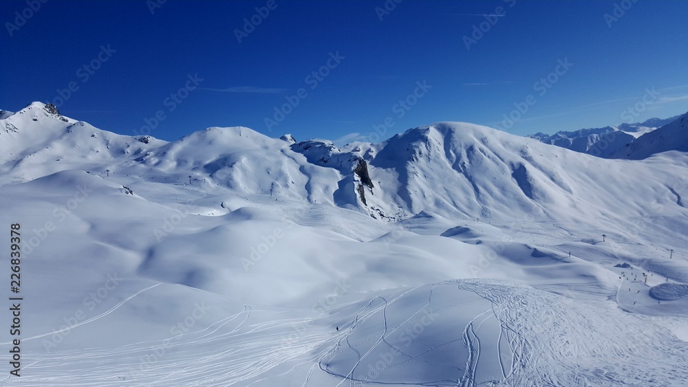 Image of ski resort in the winter with snow covered mountains and slops