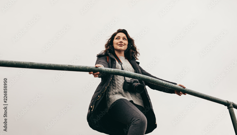 Female traveler at observing point on mountain