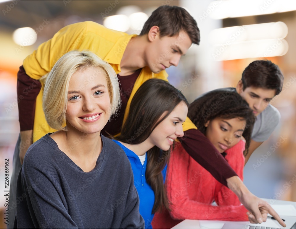 Young students studying on background