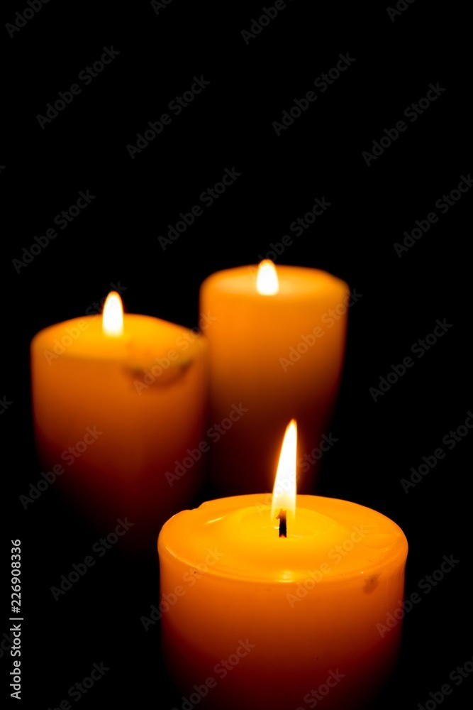 Close-Up of Three Lit Candles on Black Background