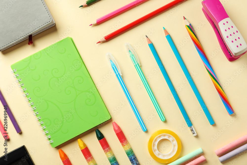 Composition with different school stationery on color background