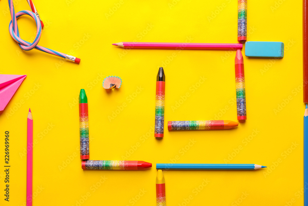 Composition with different school stationery on color background