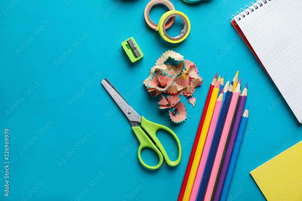 Composition with different school stationery on color background