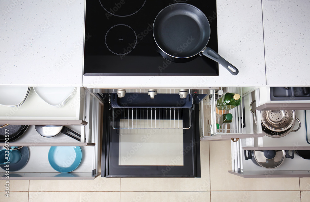 Set of clean kitchenware in drawers