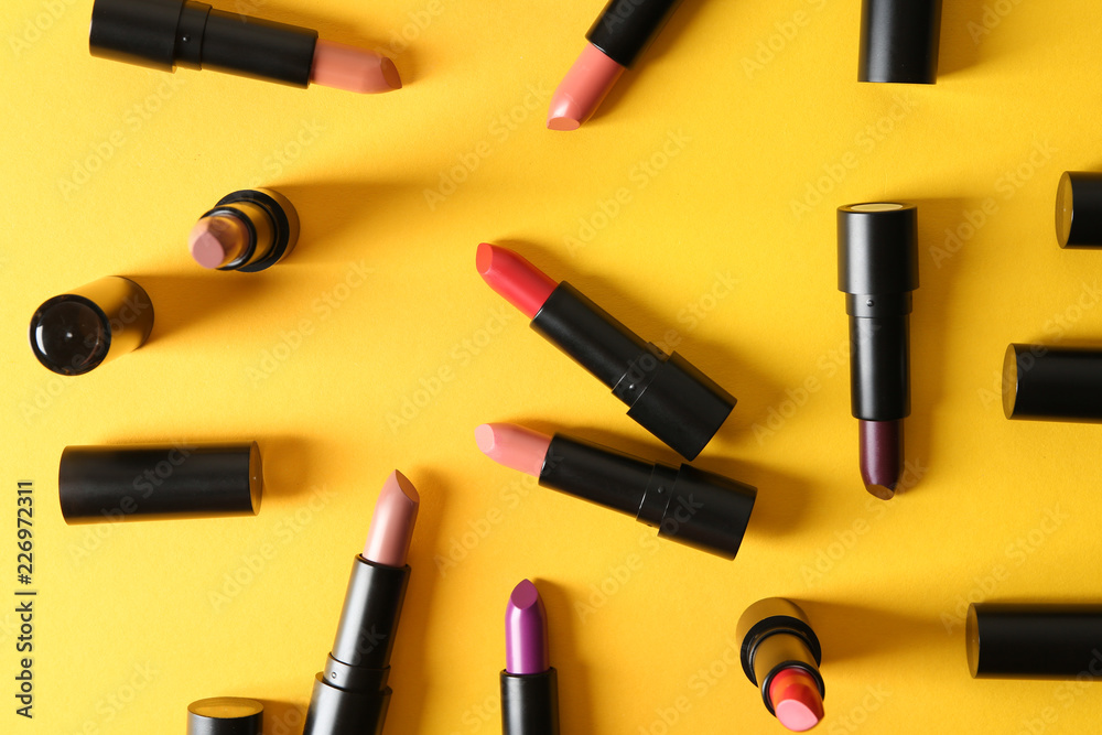 Lipsticks of different shades on color background