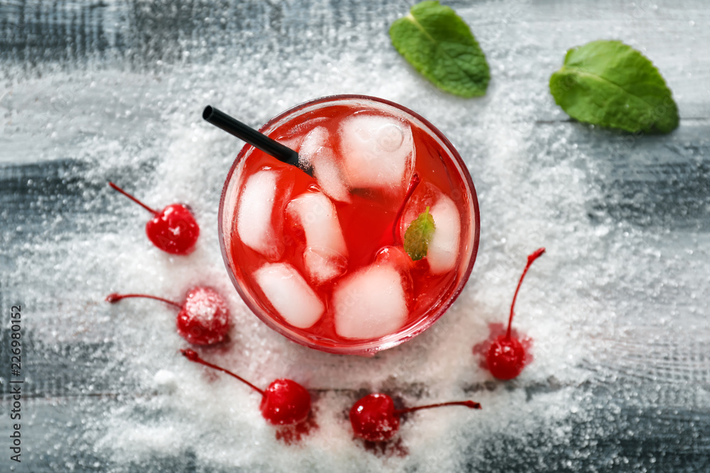 Glass with delicious summer cocktail on table