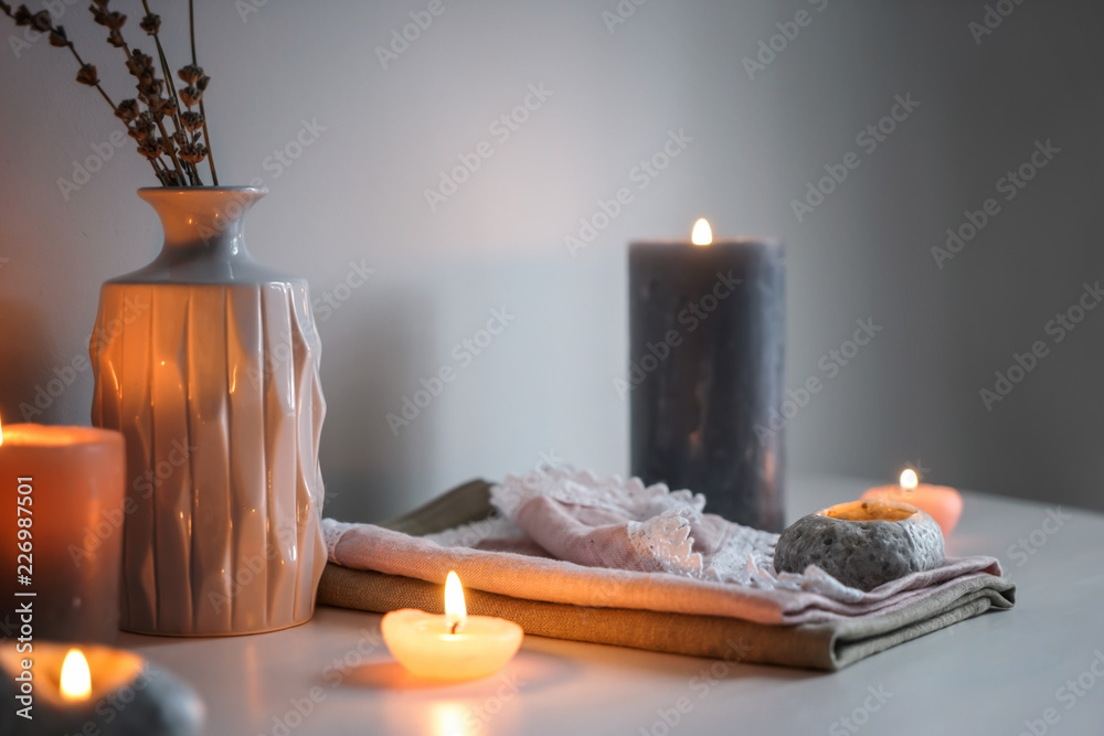 Beautiful burning candles with vase on table indoors