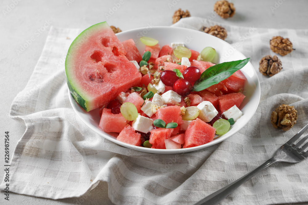 Plate with delicious watermelon salad on table