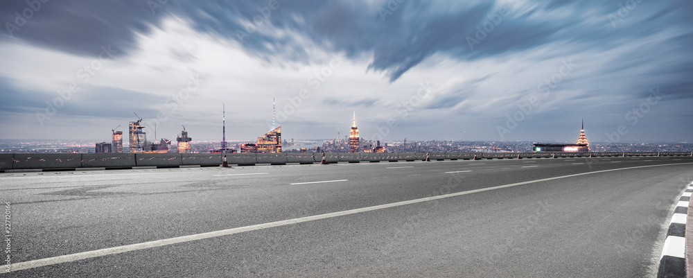 empty asphalt highway with modern cityscape new york