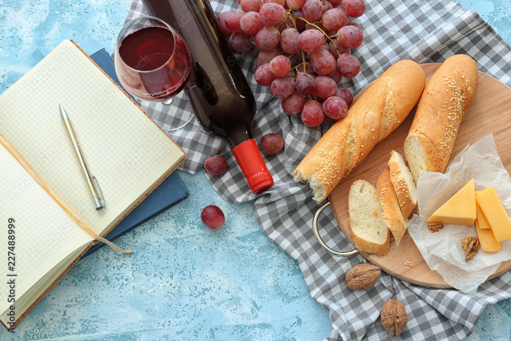 Composition with red wine, bread and cheese on table