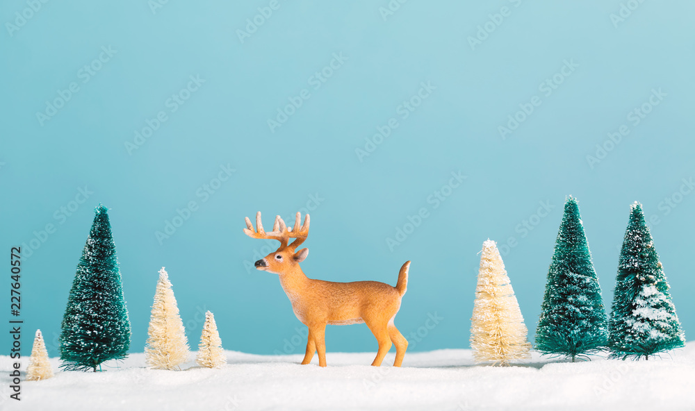 Christmas holiday theme with reindeer and Christmas trees