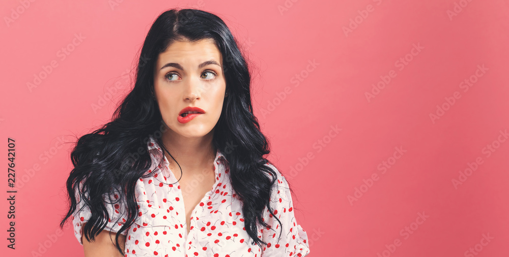 Bored young woman on a solid background