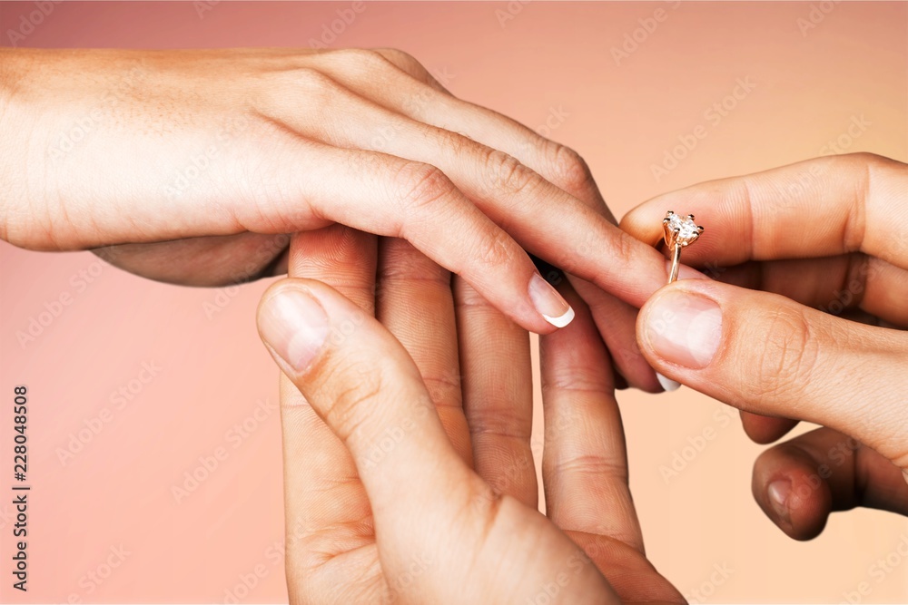 Close up Groom Putting the Wedding Ring