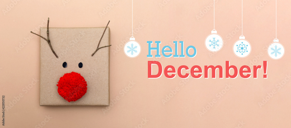 Hello December message with a red nose reindeer gift box