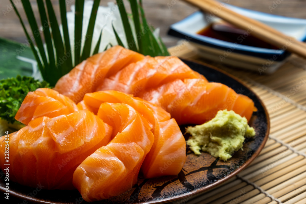 Sashimi, Salmon, Japanese food chopsticks and wasabi on the  table