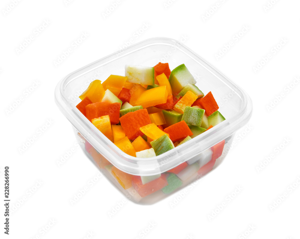 Plastic container with fresh vegetables for freezing on white background