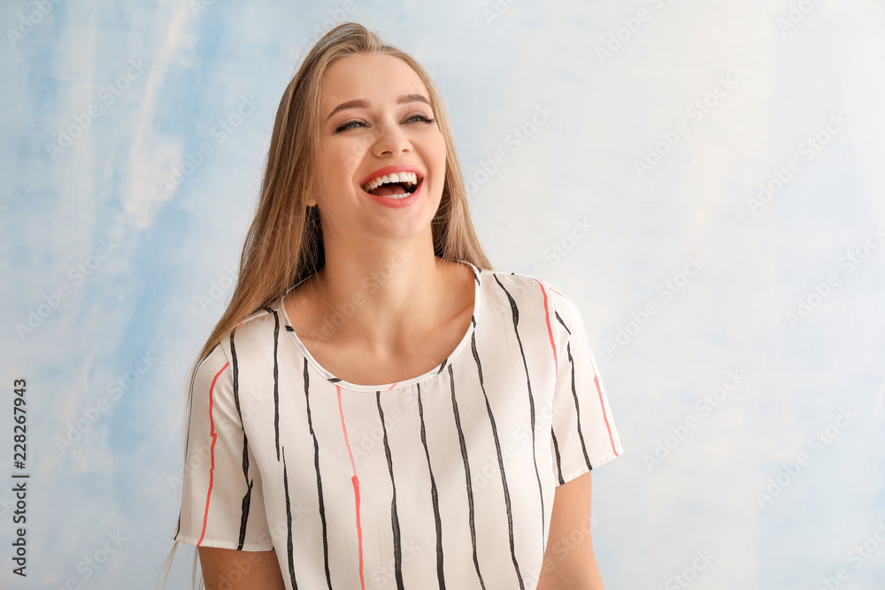 Portrait of happy beautiful young woman on color background