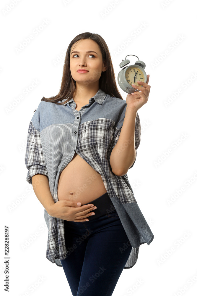 Beautiful pregnant woman with clock on white background