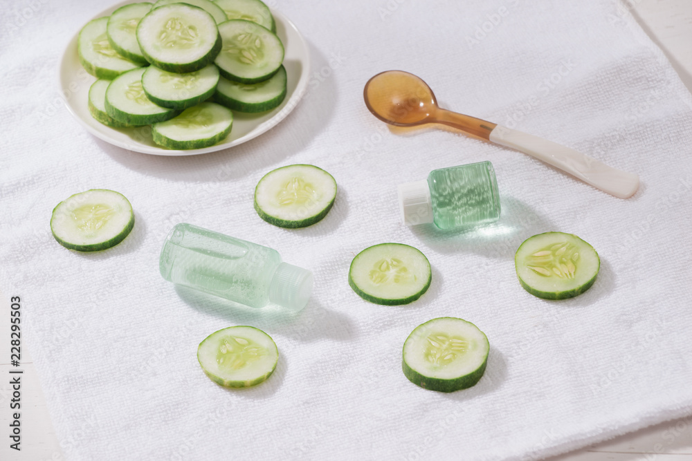 Cosmetic bottle and fresh organic cucumber for skincare. Home spa concept.