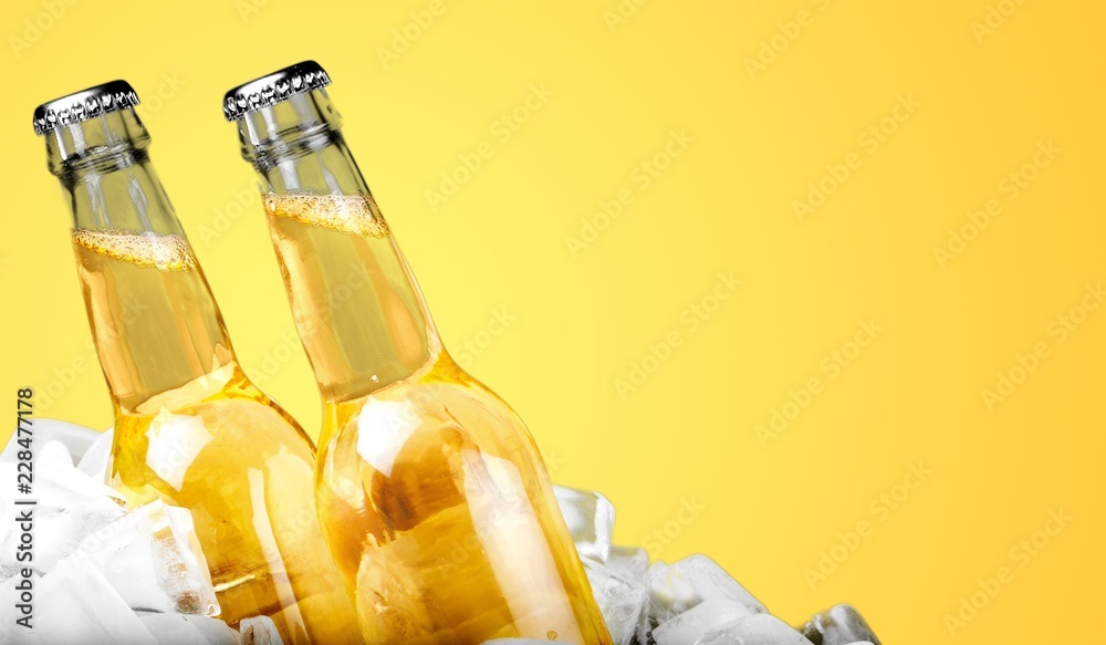 Bottles of cold and fresh beer with ice isolated