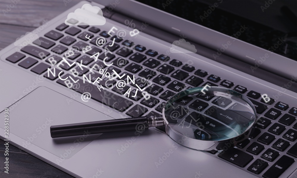 Magnifying glass on laptop, digital background