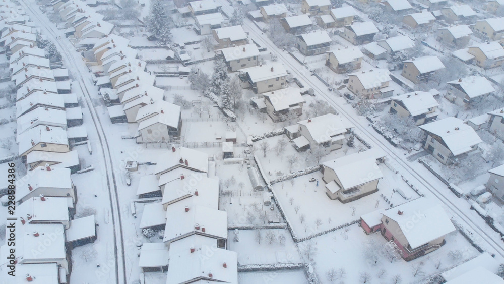 AERIAL: Flying over the empty private properties on a idyllic snowy winter day.