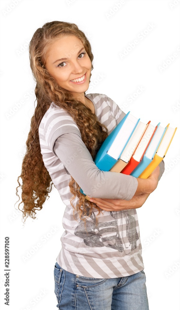 Pretty young woman with heap of books isolated on white