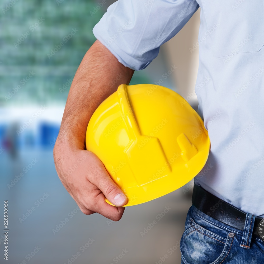 Worker man with helmet on background