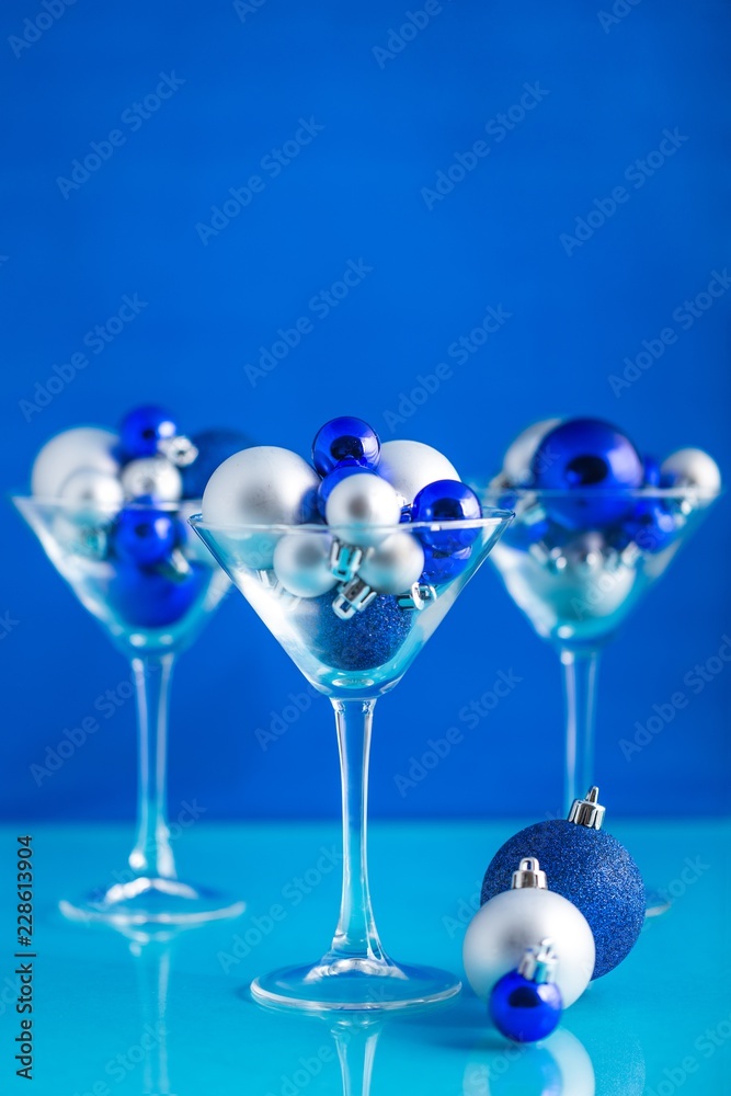 Christmas Baubles in a Martini Glasses on the Blue Background