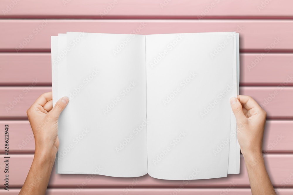 Hands holding  blank book isolated on white background