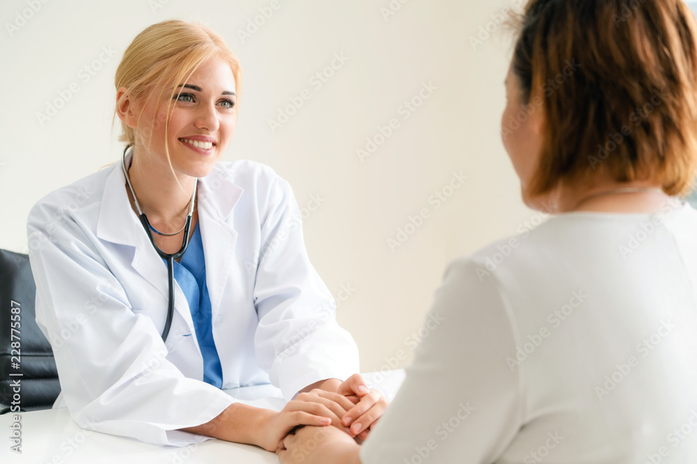 Woman Doctor and Female Patient in Hospital Office