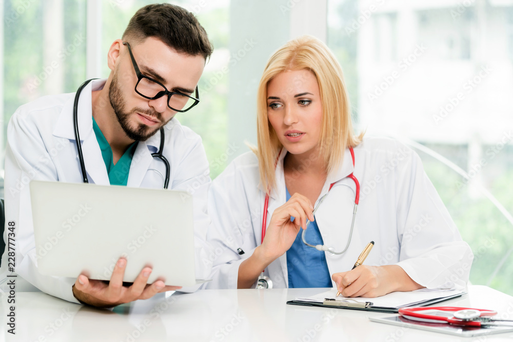 Two doctors partner works at office in hospital.