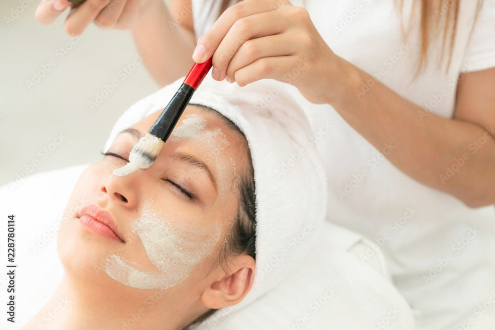 Beautiful woman having a facial treatment at spa.