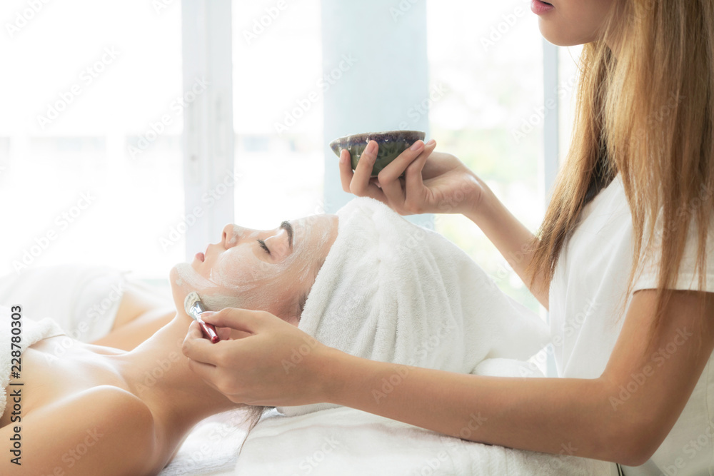 Beautiful woman having a facial treatment at spa.