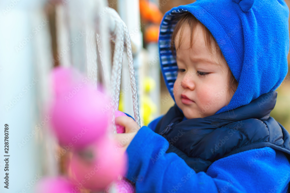 Toddler boy playing outside on an autumn day