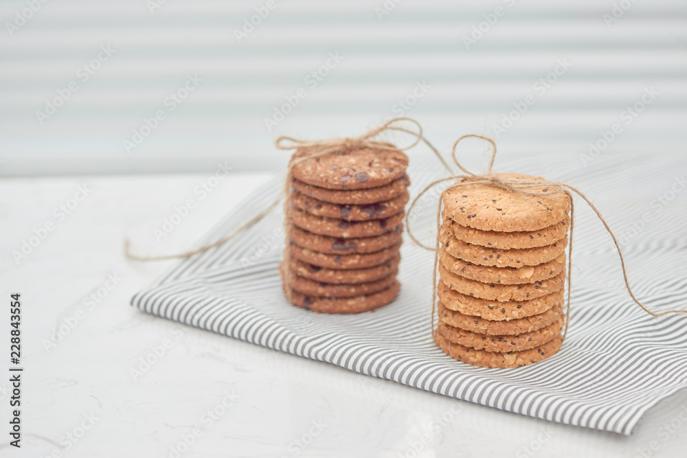 Cookie are stack and tied with twine. Delicious cookies on napkin background. Homemade cake. The nut