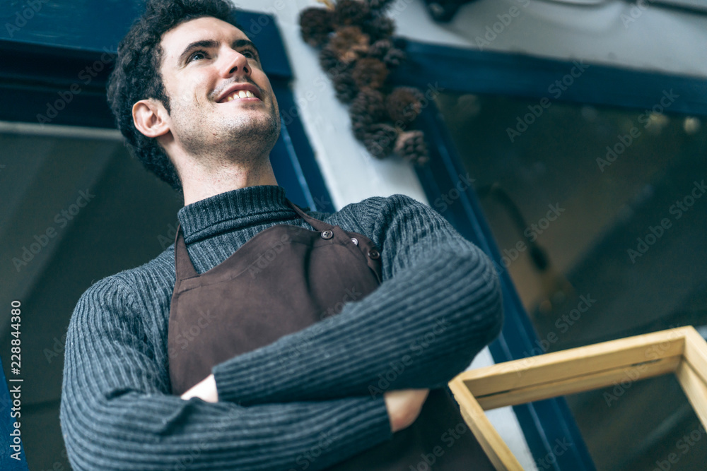 Portrait of happy young man wearing an apron attractive caucasian Male Barista cafe restaurant owner