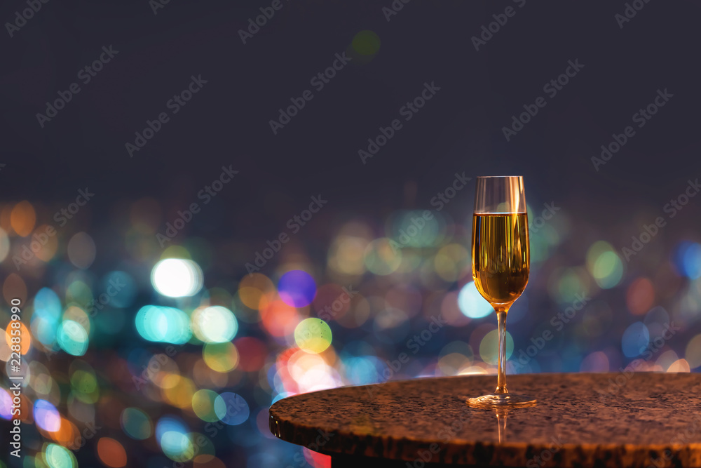 White wine on a table high above the city at night