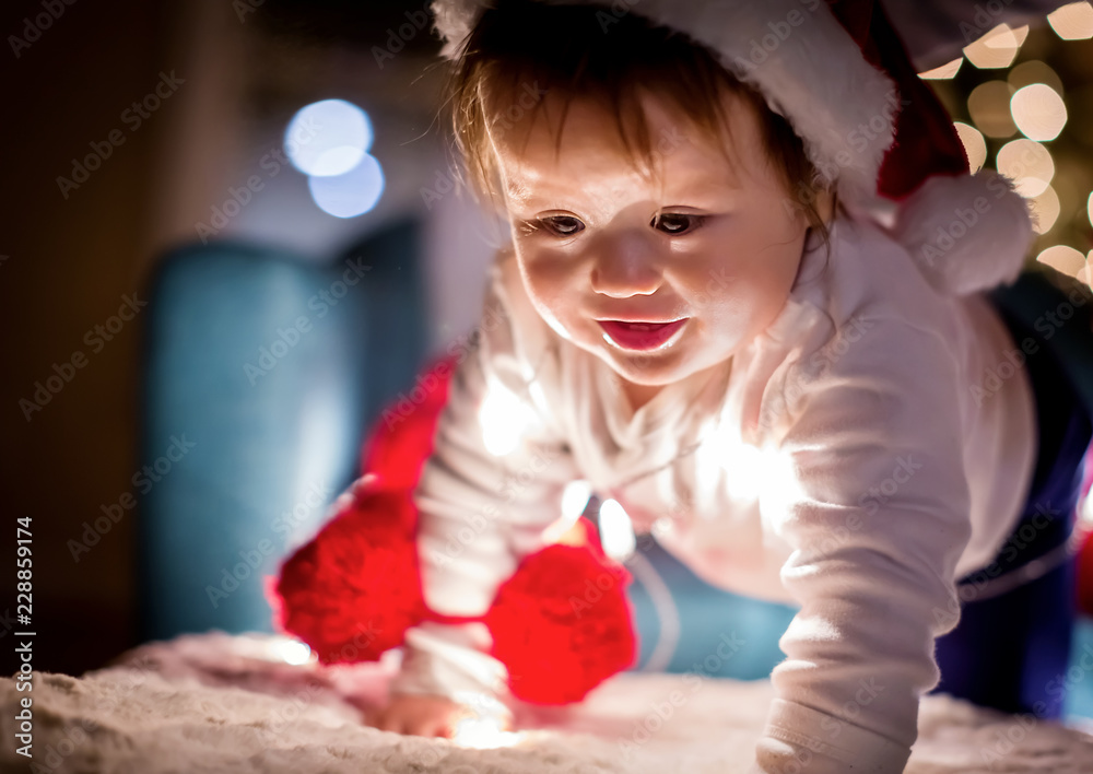 Toddler boy playing with a Santa hat around Christmas time