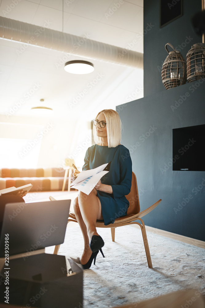 Smiling businesswoman talking with a colleague in an office