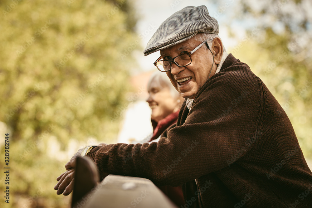 Smiling old man at park on a winter day