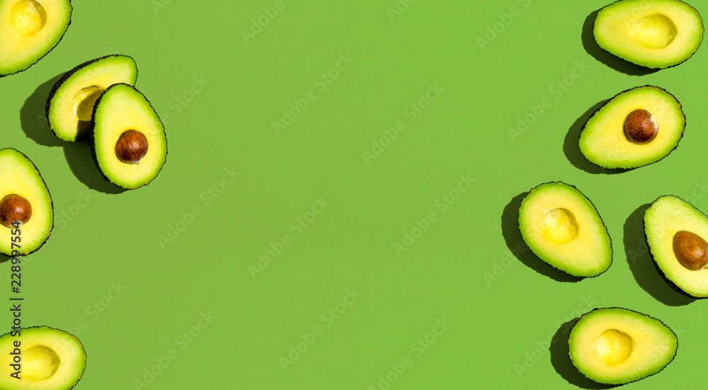 Fresh avocado pattern on a green background flat lay