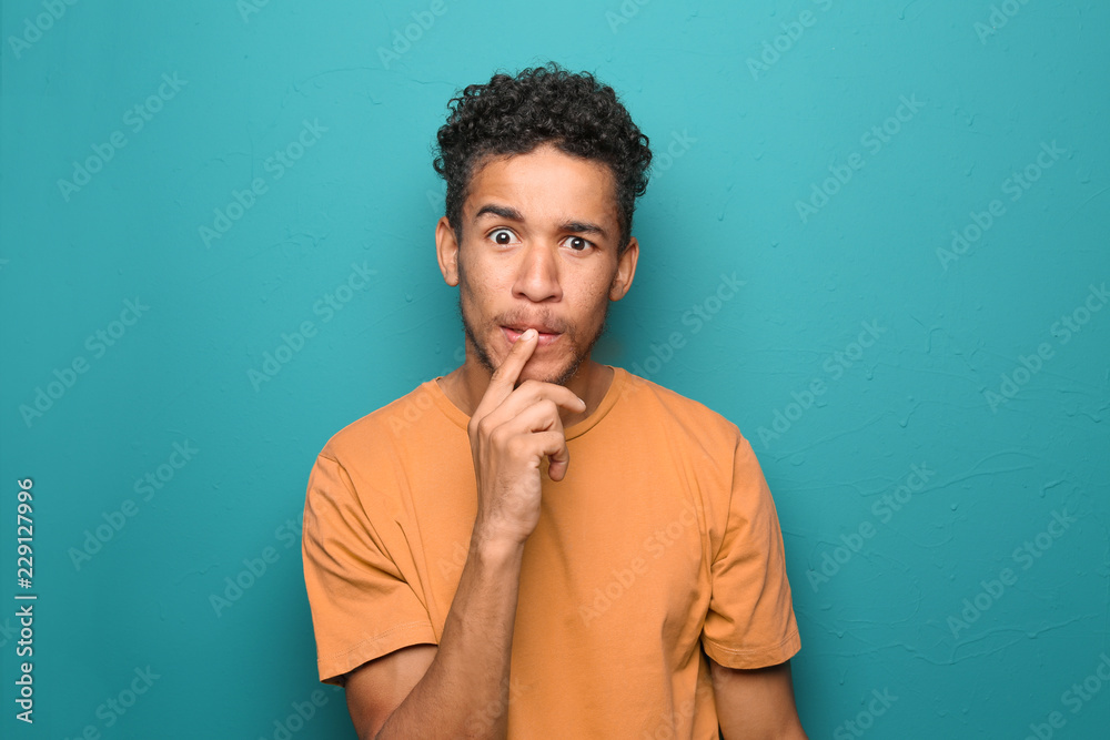 Portrait of thoughtful African-American man on color background