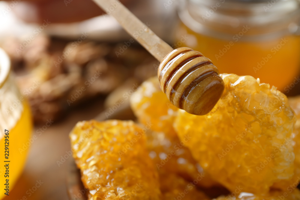 Wooden dipper and honeycomb, closeup