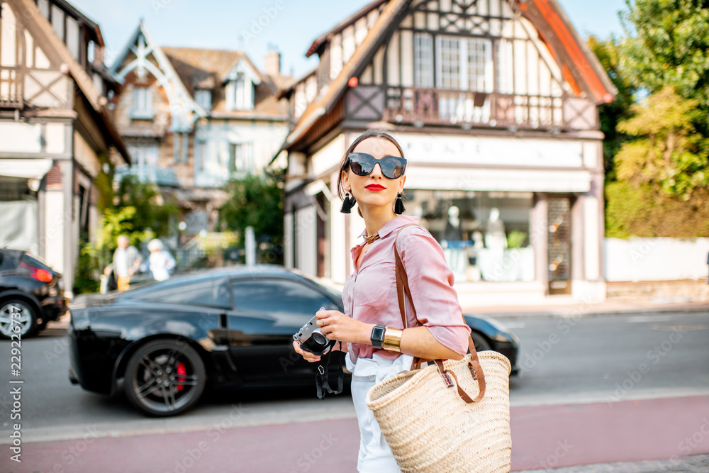 Beautiful woman walking at the old town of Deauville, famous french resort in Normandy