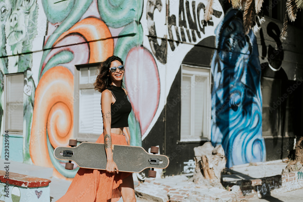 Beautiful woman holding a longboard